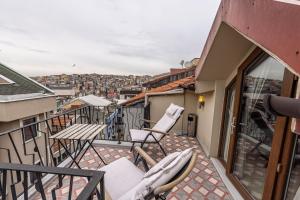 a balcony with chairs and a view of a city at Calanthe Residence in Istanbul