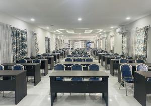 a room with rows of chairs and tables and curtains at ONYX HOTEL Yamoussoukro in Yamoussoukro