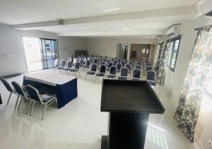 a conference room with chairs and a table and a podium at ONYX HOTEL Yamoussoukro in Yamoussoukro +39 photos