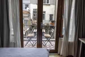 a bedroom with a window with a view of a balcony at Calanthe Residence in Istanbul