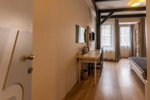 a room with a desk and a bed and a table at Calanthe Residence in Istanbul