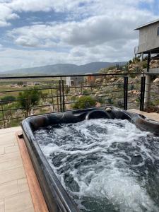 a hot tub with water in it on a deck at Siempre Valle Hotel Boutique in Valle de Guadalupe