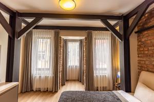 a bedroom with a bed and two windows at Calanthe Residence in Istanbul