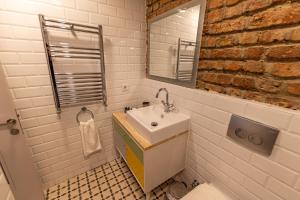 a bathroom with a sink and a mirror at Calanthe Residence in Istanbul