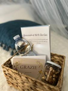 a basket with a bottle of perfume and a jar of candy at B&B Zio Cici in Minervino di Lecce