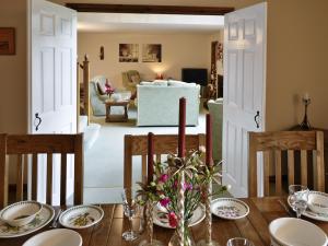 a dining room with a table and a living room at Wheelhousee - Hmq in Combe Martin