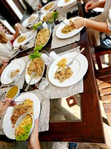 a long table with plates of food on it at Chill River Villa - Villa with Scenic River Views in Weligama