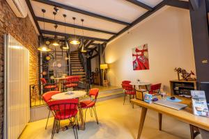 a restaurant with red chairs and tables in a room at Calanthe Residence in Istanbul