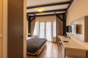 a hotel room with a bed and a desk at Calanthe Residence in Istanbul