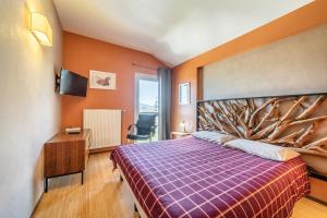 um quarto com uma cama grande e uma cabeceira de árvore em Gîte Le Jorat - Appartement C em Bogève