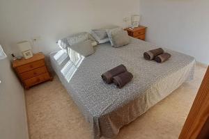 ein Schlafzimmer mit einem großen Bett mit zwei Kissen darauf in der Unterkunft Casa Marrón, Playa Flamenca in Playa Flamenca