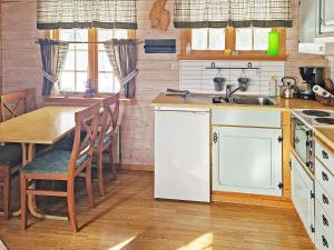 a kitchen with a wooden table and a sink and a table at 6 person holiday home in Nordli in Holand