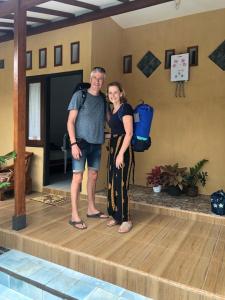 a man and a woman standing on a dance floor at Nitha Homestay in Banyuwangi