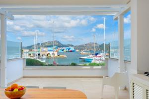 a kitchen with a large window overlooking a marina at Olbia Luxury Apartment in Olbia