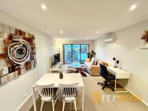 a living room with a table and chairs and a couch at Beige & Beautiful - 1bd 1bth Apt - Close to ANU in Canberra
