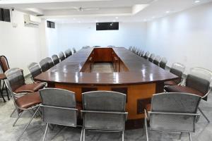 a large conference room with a large table and chairs at Hotel Holiday Pride in Aurangabad