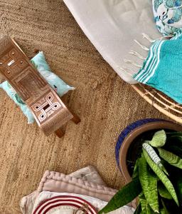 a wooden toy sitting on the floor next to a pillow at Maison Taina in Arue +42 photos