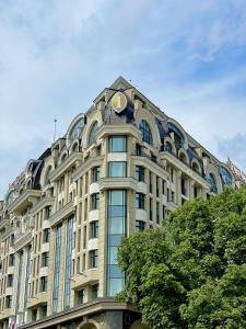 a large building with a clock on the top of it at InterContinental - Kyiv, an IHG Hotel in Kyiv