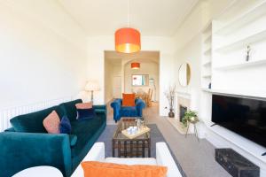 a living room with a couch and a tv at Spacious and quiet ground floor flat in Bristol