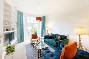 a living room with a couch and a table at Spacious and quiet ground floor flat in Bristol