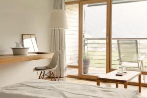 A bed or beds in a room at Hotel Post Bezau