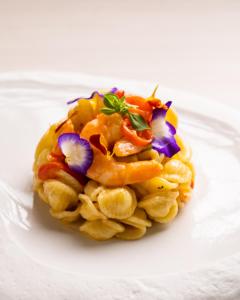 a plate of food with shrimp and flowers on it at Hotel Florence in Marotta