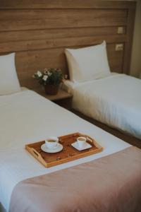 two cups of coffee on a tray on two beds at Twins Wine House in Napareuli