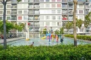 a water park in front of a large building at Bandar Saujana Putra BSP 21 AZFA Suite [FREE WiFi] in Jenjarum