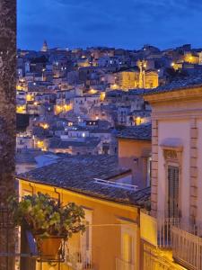 a view of a city at night at B&B L'Orto Sul Tetto in Ragusa