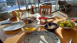 a table with plates and bowls of food on it at Nordic character in Vidsel