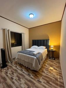 a bedroom with a large bed and a window at Casa Hacienda Real in Siguatepeque