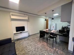 a living room with a dining table and a kitchen at LK Savassi 5 in Belo Horizonte +13 photos