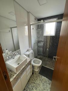 a bathroom with a sink and a toilet at LK Savassi 5 in Belo Horizonte