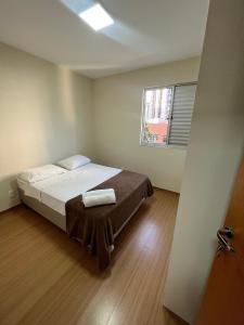 a bedroom with a bed with two towels on it at LK Savassi 5 in Belo Horizonte