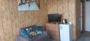 a living room with a couch and a television at Happy beach in Varna City
