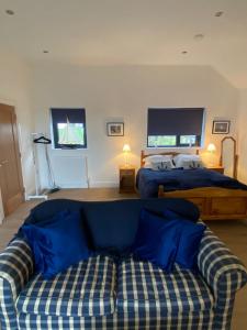a living room with a couch and a bed at The Boathouse in Donaghadee