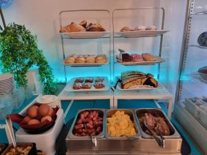 a refrigerator filled with lots of different types of pastries at Hotel Orchidea in Lignano Sabbiadoro