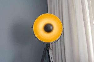 a large yellow object on a tripod next to a curtain at MariGold by Destiny Houses in Senhora da Hora