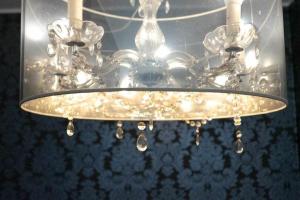 a chandelier hanging from a ceiling in a room at MariGold by Destiny Houses in Senhora da Hora