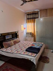 a bedroom with a large bed in a room at Stacy Guest House in Jīnd