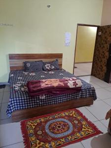 a bedroom with two beds and two rugs on the floor at Stacy Guest House in Jīnd