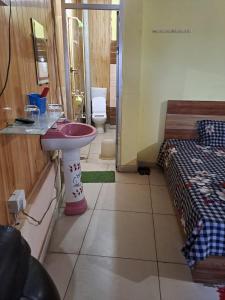 a bathroom with a sink and a bed at Stacy Guest House in Jīnd