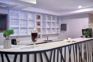 a bar with a wine glass sitting on a counter at ACTUEL LİFE HOTEL in Istanbul