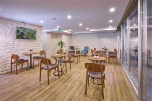 a restaurant with tables and chairs and a brick wall at Actuel Life Hotel in Istanbul