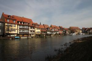 a river with houses and buildings next to a river at Altstadtpalais im Sand in Bamberg