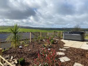 a garden with a grill in the middle of a yard at Bimbling Cottage in Redruth