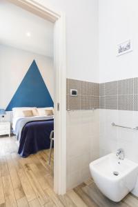 a bathroom with a bed and a sink and a shower at Scaramantico Rooms in Naples +77 photos