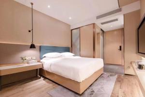 Voodi või voodid majutusasutuse Chaoman Hotel -Guangzhou Shijing City Plaza Xiaoping Subway Station toas