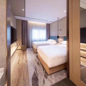 Voodi või voodid majutusasutuse Chaoman Hotel -Guangzhou Shijing City Plaza Xiaoping Subway Station toas