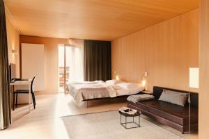 A bed or beds in a room at Hotel Post Bezau